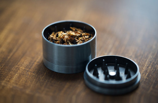 close up of marijuana or tobacco and herb grinder