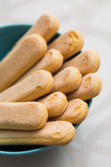 Ladyfinger cookies in the blue bowl; ladyfingers are most notabl