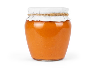 squash puree in a glass jar on a white background