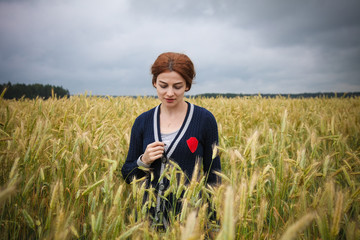 Naklejka na ściany i meble Woman in wheat field