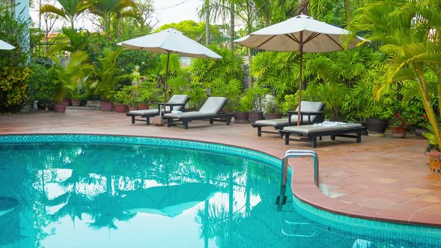 High definition video - Sunbeds and umbrellas around the pool at the hotel