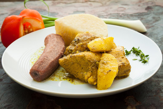 Curried Chicken served with boiled bananas and yams.