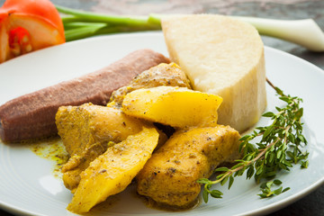 Curried Chicken served with boiled bananas and yams.