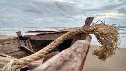 Boat Tail of Wooden Boat at Beach on Stormy Day