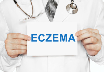 Doctor holding a card with Eczema, medical concept