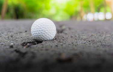 Golf ball on Lane Blacktop rough roads