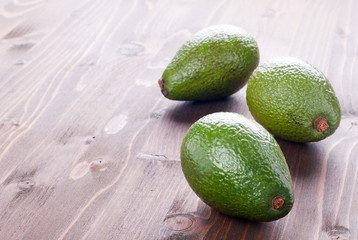 three ripe avocado on the table
