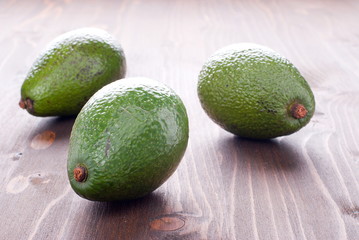 three ripe avocado on the table