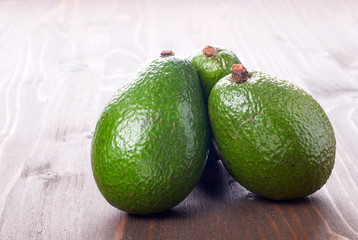 three ripe avocado on the table