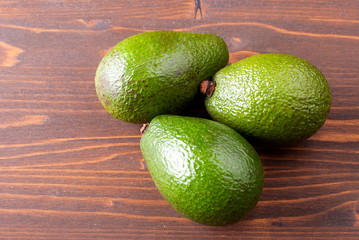 three ripe avocado on the table