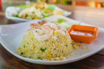 fried rice with shrimp white plates on the table