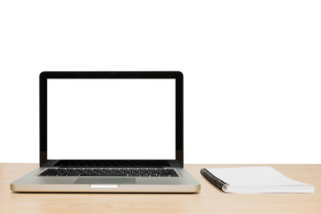 Open laptop with isolated white screen and book on wooden