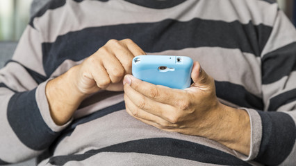 Close up of a man using mobile smart phone