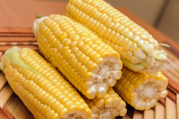 Fresh corn on cobs rustic wooden table, closeup