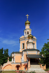 Traditional orthodox temple with gold domes against the blue sky.