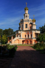 Fototapeta na wymiar Traditional orthodox temple with gold domes against the blue sky.