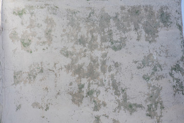 old white wall peeled spotted with cracks