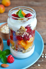 Homemade yogurt with granola, almonds, peaches and raspberries o