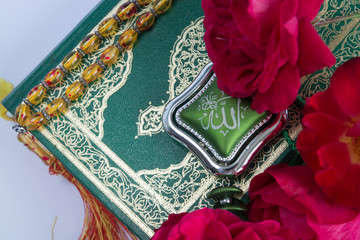 Koran on white background with rosary