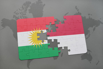 puzzle with the national flag of kurdistan and indonesia on a world map background.