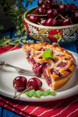 Homemade cherry pie on blue table.