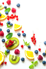 Fresh summer berries and fruits on white