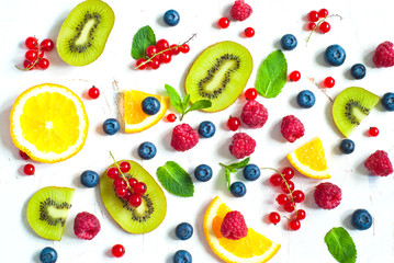 Fresh summer berries and fruits on white