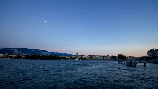 Day to night timelapse of Geneva city skyline and lake.