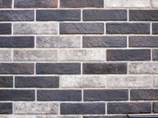 Decorative brickwork closeup of gray and black bricks