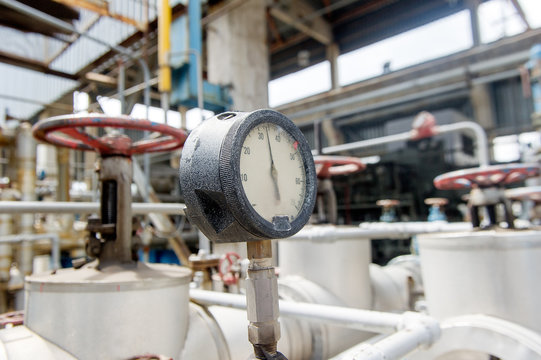 Pressure meter in natural gas processing plant in bright sunny summer day