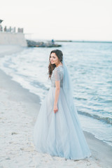 Fototapeta na wymiar Cheerful bride at the seashore