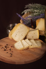 Various cheeses on the wooden board