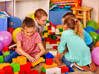Group children game blocks on floor in primary school. Top view class of primary school.