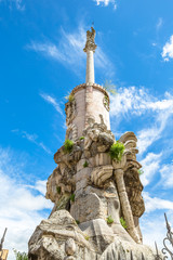 Triunfo de San Rafael, monument in honor of the Archangel, in the blue sky. Cordoba, Andalusia, Spain.