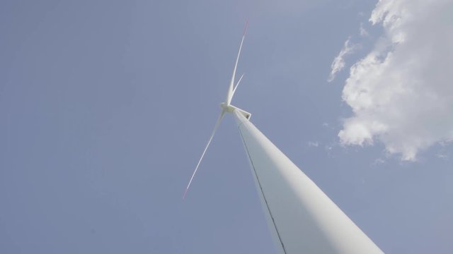 Windturbine gegen blauen Himmel - 4K UHD Windkraftwerk zur Stromproduktion