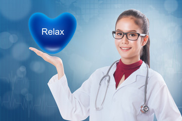 Female doctor holding heart with relax sign on medical background.