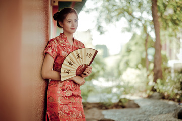 The Asian woman in chinese dress holding couplet 'success' (Chin