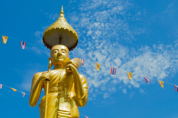 Samutprakarn, Thailand - July 19; Thai Buddhist decorate temple and Statue with Thailand flag and yellow Buddhism symbol flag to celebrating on Asalha Puja day before Khao Phansa day.