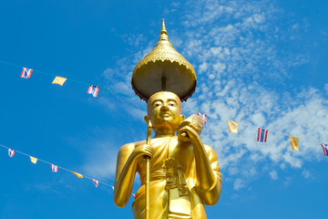 Samutprakarn, Thailand - July 19; Thai Buddhist decorate temple and Statue with Thailand flag and yellow Buddhism symbol flag to celebrating on Asalha Puja day before Khao Phansa day.