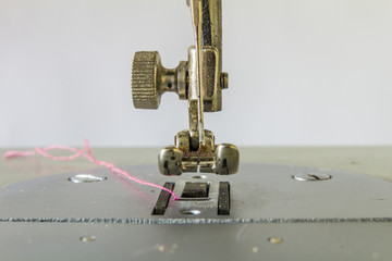 Close-up detail of the sewing machine with a broken needle