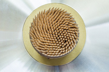 Abstract wooden toothpicks on a metal background