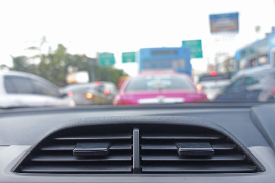 Air conditioning car vent on the blur traffic background.