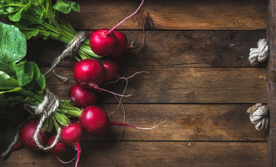 Fresh radish banches on wooden tray background, copy space