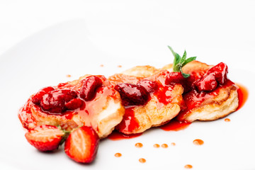Delicious pancakes with strawberry jam on white background. Appetizing homemade dessert with fresh berries, copyspace