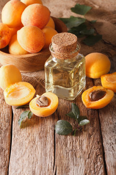 apricot kernel oil in a glass jar closeup and ingredients. vertical

