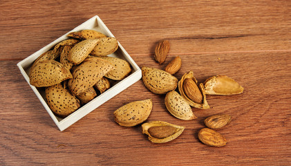 Almonds and almond nuts on a rustic wood background