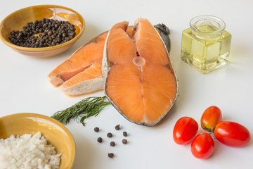 fresh fish salmon raw salmon steak with sea salt pepper and Dill Weed isolated on a white background