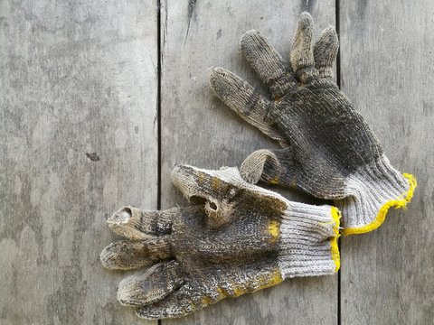 dirty gloves on old wood background