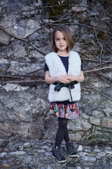 Teenager female in a white warm fur jacket.