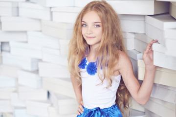 Fototapeta na wymiar Cute blond teenager female in a blue skirt.